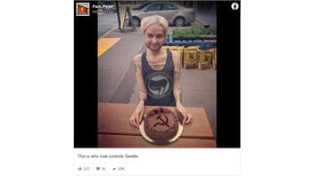 Fact Check: NOT A Photo Of An Antifa Activist Posing With A Hammer-And-Sickle Cake