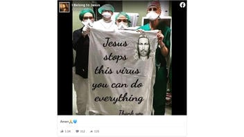 Fact Check:  A Viral Photo Of Doctors And Nurses In Italy Does NOT Show Them Holding A Sign Saying, 'Jesus Stops This Virus'
