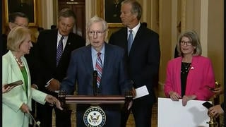 Fact Check: 'Lady In Green' Did NOT Hypnotize Mitch McConnell, Freezing Him With A Touch -- Sen. Capito Was Standing Behind Him With Others