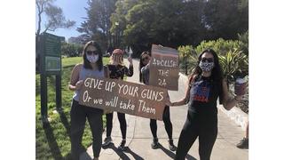 Fact Check: FAKE Photo Has Biden, Harris Supporters Holding 'Give Up Your Guns' And 'Abolish The 2A' Signs 