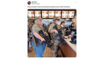 Fact Check: FAKE Photo Shows 2 Heavily Armed Men In Line At Fast Food Restaurant