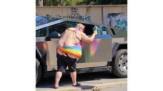 Fact Check: AI Photo Does NOT Show Tesla Cybertruck Vandalized By Real Person In Rainbow Colored Clothing