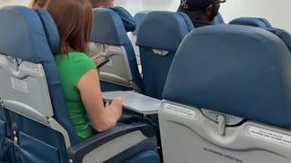 Fact Check: Skit Of Woman Annoying Man By Bashing Tray Table Against Airplane Seat Is NOT Real