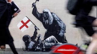 Fact Check: Banksy London Wall Art Did NOT Show Judge Striking Protester Holding English Flag -- It Was A White Placard Splashed With Blood