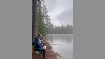 Fact Check: Lightning Strike At Fishing Spot Is NOT Real -- AI Generated Video Shows An Unlikely Reaction