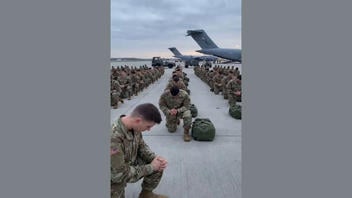 Fact Check: FAKE Video Shows Deploying U.S. Soldiers Kneeling In Prayer On A Runway