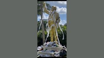 Fact Check: FAKE Photo Shows Golden Trump Statue Covered In Toilet Paper And Trash