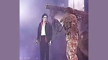 Fact Check: Video Does NOT Show Real Attacker Threatening Michael Jackson With A Rifle On Stage -- It Was A Scripted Concert Scene