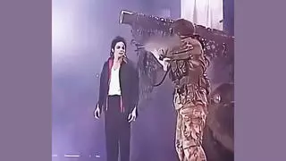 Fact Check: Video Does NOT Show Real Attacker Threatening Michael Jackson With A Rifle On Stage -- It Was A Scripted Concert Scene