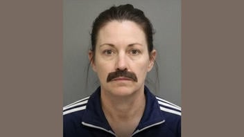 Fact Check: FAKE Mugshot Shows Woman Arrested For Disguising Herself As A Man To Enter A BBQ Competition