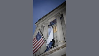Fact Check: FAKE Video Shows Man Tearing Down Trump Banner At Department of Justice -- It's AI