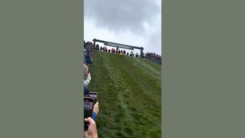 Fact Check: FAKE Video Shows Woman In Swimsuit Winning Cheese-Rolling Race Down Hill