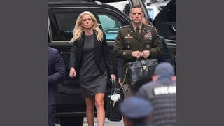 Fact Check: ALTERED Photo Shows Army Officer With 'Nuclear Football' Chained To 'Diaper Bag' 
