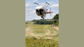 Fact Check: FAKE Video Shows Helicopter Landing Upside Down In A Field -- AI-Generated