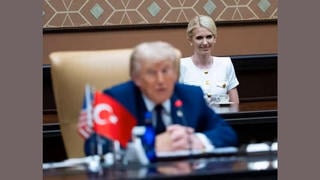 Fact Check: FAKE Video Shows Natalie Harp Grinning Over Trump's Shoulder -- AI-Generated