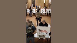 Fact Check: FAKE Video Shows Masked Police Officers Walking Around Polling Station, Looking At How People Are Voting