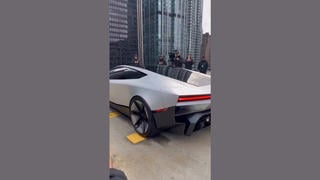 Fact Check: FAKE Video Shows Tesla Roadster Flying Off Building Roof In The Middle Of A City -- It Is AI-Generated