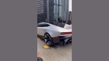 Fact Check: FAKE Video Shows Tesla Roadster Flying Off Building Roof In The Middle Of A City -- It Is AI-Generated